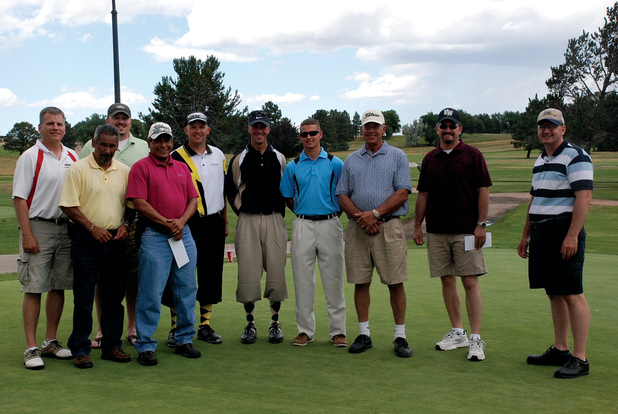 The second place team consisting of Gil Ferrel, Nick Lumbreraz, Dan Conrad and Jeff Allen, all from the 90th Mission Support Group; the third place team of Tech. Sgt. Bryan Broberg, Tech. Sgt. Jamie Lund, Larry Stockdale and Airman 1st Class Bryan Gill, all from the 90th Security Forces Group; and the first place team of Tom Deville, Chief Master Sgt. Marty Anderson, Mark Ragsdale (not pictured) and Capt. Mike Young (not pictured), all from the 90th Missile Wing; pose for a group shot of all the winners from the Global Strike Challenge golf tournament Aug. 6. (U.S. Air Force photo by Staff Sgt. Mike Tryon)