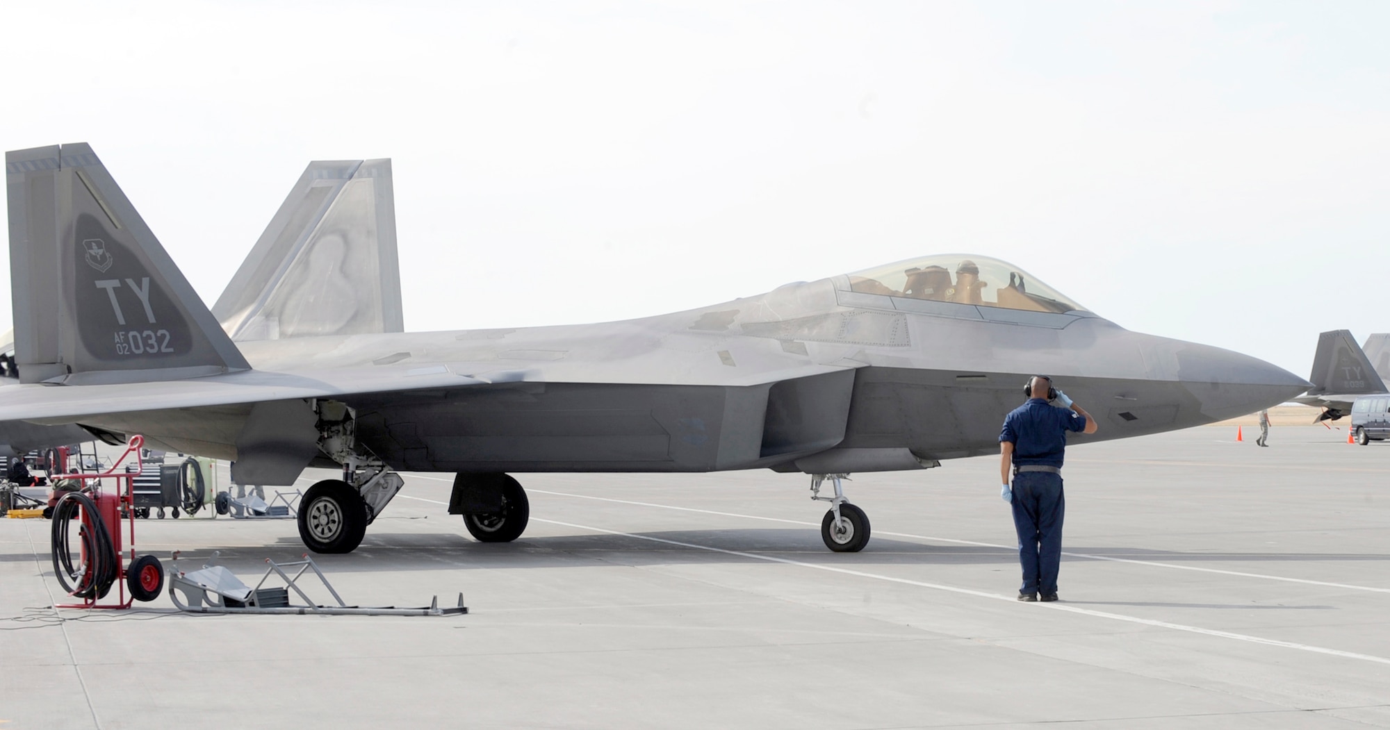 Senior Airman Dez Watson salutes an F-22 Raptor as it taxis toward the runway Aug 6, 2010, at Mountain Home Air Force Base, Idaho. More than 150 Airmen and 12 F-22s from the 43rd Fighter Squadron at Tyndall AFB, Fla., arrived July 31, 2010, in support of the Air Force's first Exercise Global Gem joint training. Airman Watson is a 43rd Aircraft Maintenance Unit crew chief. (U.S. Air Force photo/Airman 1st Class Debbie Lockhart)