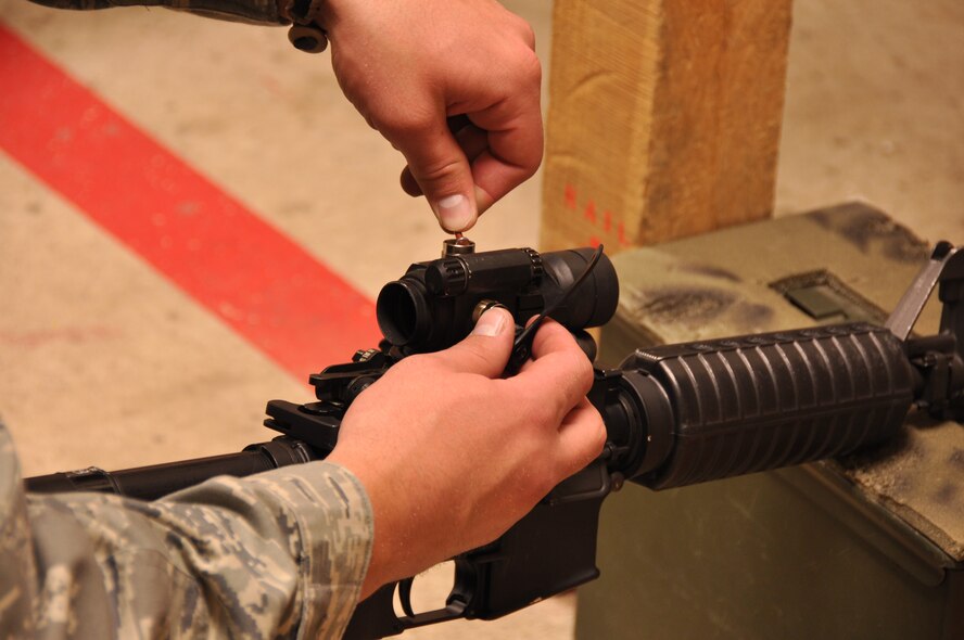 An Airman in the 419th Security Forces Squadron adjusts the sights on his weapon to help maintain better control and accuracy while firing. (U.S. Air Force photo/ Staff Sgt. Heather Skinkle)