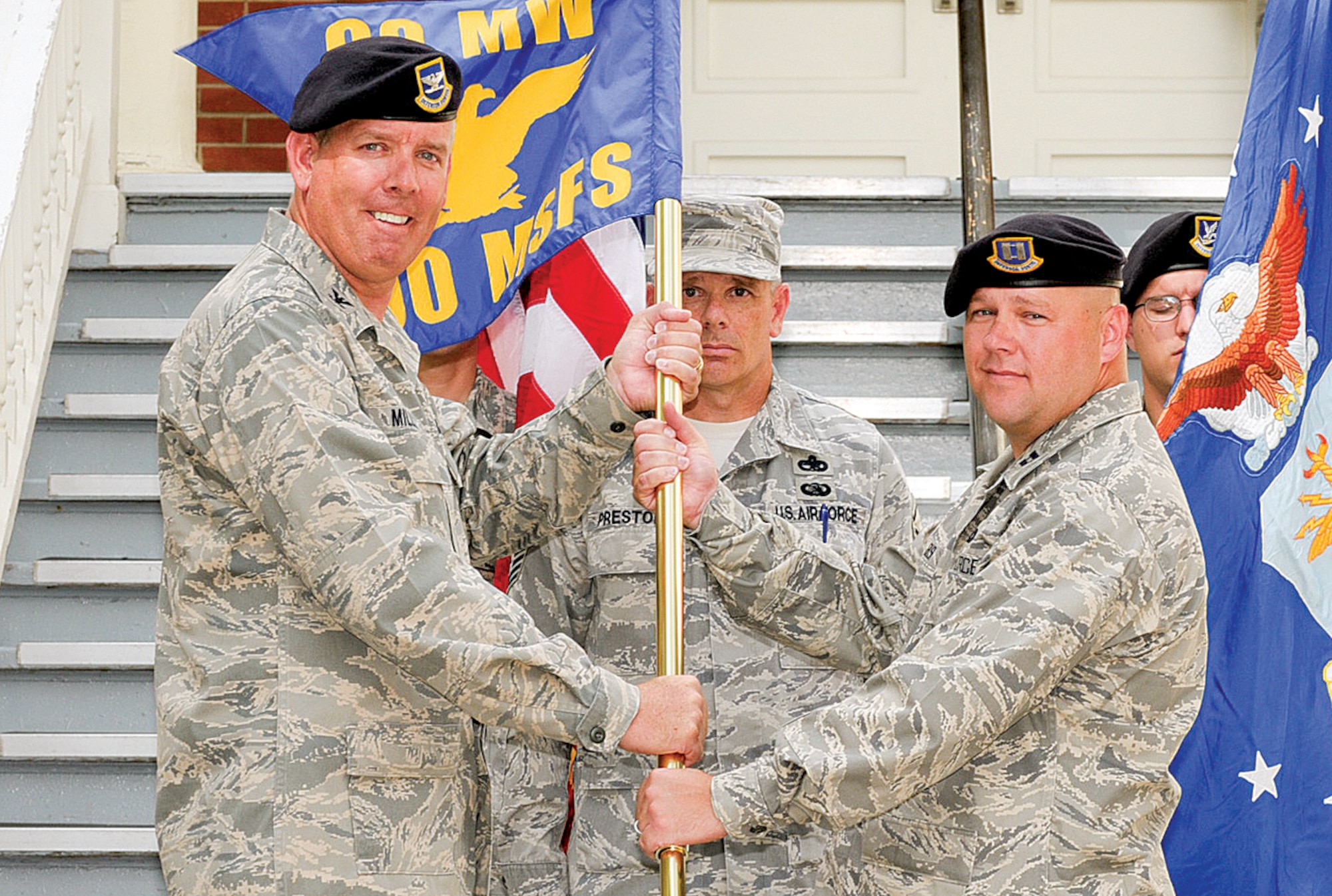Capt. Kenneth Bush assumes command of the 790th Missile Security Forces Squadron from Lt. Col. Shannon Smith on Aug. 6. Col. Steve Miller, 90th Security Forces Group commander, presented Captain Bush with the 790th MSFS guideon during the change-of-command ceremony which was held in front of Bldg. 34, the security forces group headquarters. (U.S. Air Force photo by Gerald Teano)