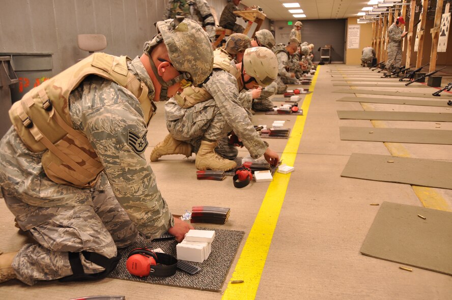 Members of the 419th Security Forces Squadron firing the M-4 assault rifle pause to reload rounds into magazine clips on the base range. Security forces armed up during the August UTA to qualify on the M-4 rifle to maintain deployment requirements and prepare for this week’s exercise. (U.S. Air Force photo/ Staff Sgt. Heather Skinkle)