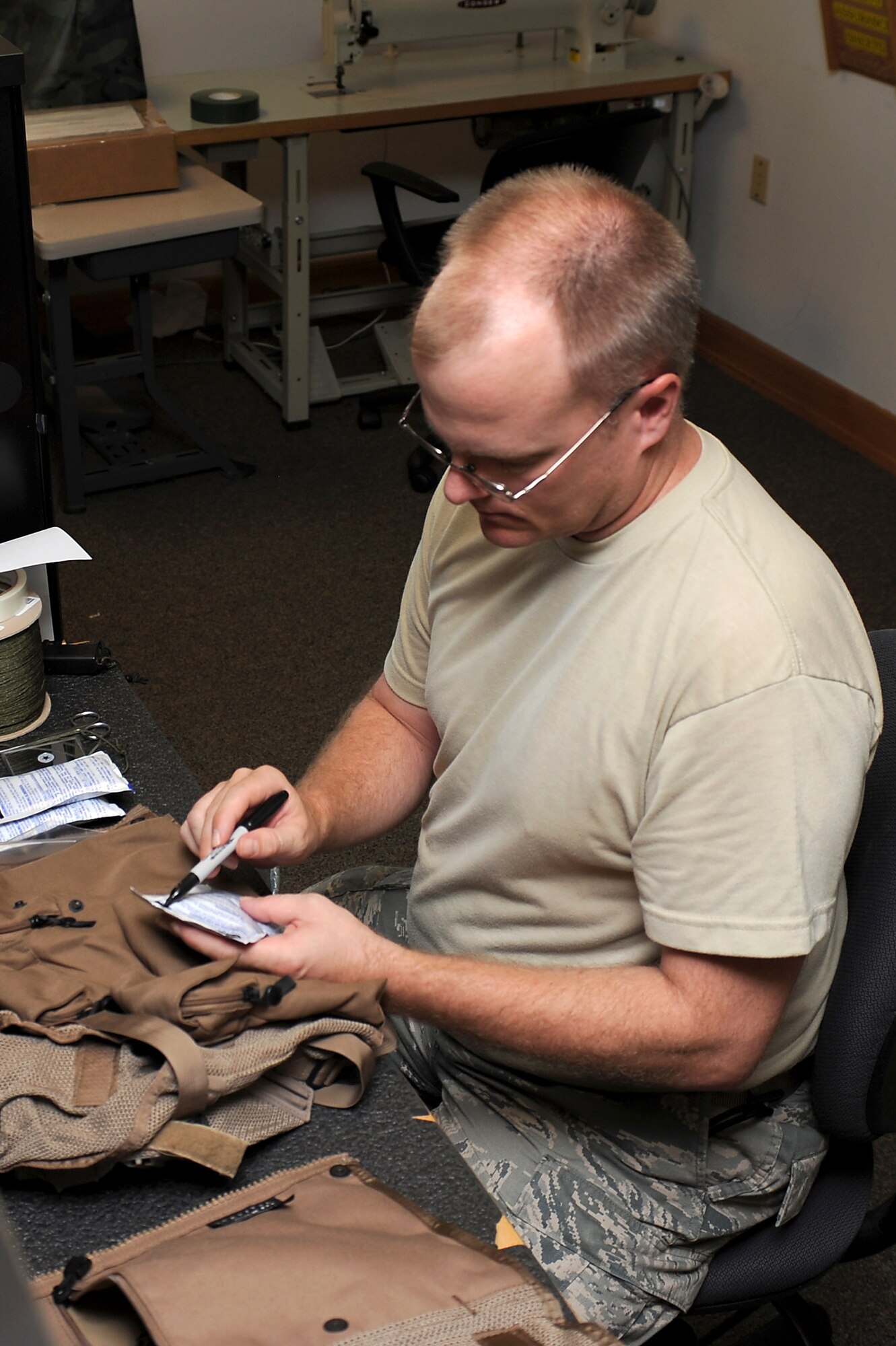 SEYMOUR JOHNSON AIR FORCE BASE, N.C.--  Tech. Sgt. Brian Timp re-stocks a survival vest during the 336th Fighter Squadron's Battle Rhythm Exercise here Aug. 3, 2010. To increase the reality of the exercise, participants worked on real world timelines that mirror deployed flight operations, maintenance turns, weapons reloading and schedules. Sergeant Timp is a 4th Operations Support Squadron aircrew flight equipment technician. (U.S. Air Force photo/Master Sgt. Brandt Smith)