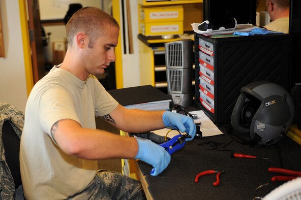 SEYMOUR JOHNSON AIR FORCE BASE, N.C. -- Senior Airman Erving Perkins, 4th Operations Support Squadron aircrew flight technician, re-assembles an aircrew mask during the 336th Fighter Squadron's Battle Rhythm Exercise here Aug. 3, 2010. During the exercise, F-15E pilots were able to use the joint helmet-mounted cueing system, which is a custom-fit helmet that increases the pilots' overall situational awareness and allows them to quickly cue the targeting pod. (U.S. Air Force photo/Master Sgt. Brandt Smith)