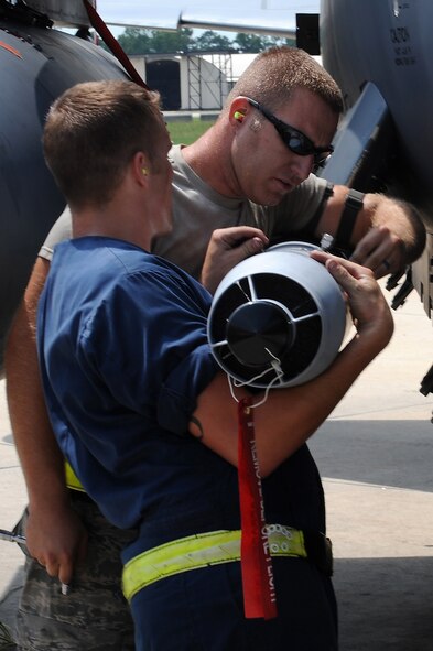 SEYMOUR JOHNSON AIR FORCE BASE, N.C. -- Staff Sgt. Brandon Criswell (right) assist Senior Airman Christopher Simison with positioning a GBU-12 bomb unit on a F-15E Strike Eagle the 336th Fighter Squadron's Battle Rhythm Exercise here Aug. 3, 2010. Exercise participants included the active-duty Airmen, Reservist, Guardsmen and Soldiers from as far away as Oklahoma, in specialties ranging from special tactics to aerial refueling. Sergeant Criswell is a 4th Aircraft Maintenance Squadron weapons load crew chief and Airman Simison is a 4th AMXS weapons load crew member. (U.S. Air Force photo/Master Sgt. Brandt Smith)