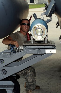 SEYMOUR JOHNSON AIR FORCE BASE, N.C. -- Staff Sgt. Brandon Criswell, 4th Aircraft Maintenance Squadron weapons load crew chief, positions a GBU-12 bomb unit for loading on an F-15E Strike Eagle as a part of the 336th Fighter Squadron's battle rhythm exercise here Aug. 3, 2010. The "Rockets" spent the week honing the skills they need to work with conventional and special operations joint tactical air controllers, including flying with F-16 Fighting Falcons, E-3 Sentries, E-8C Joint Stars and KC-135 Stratotankers, and employing their weapons systems. (U.S. Air Force photo/Master Sgt. Brandt Smith)