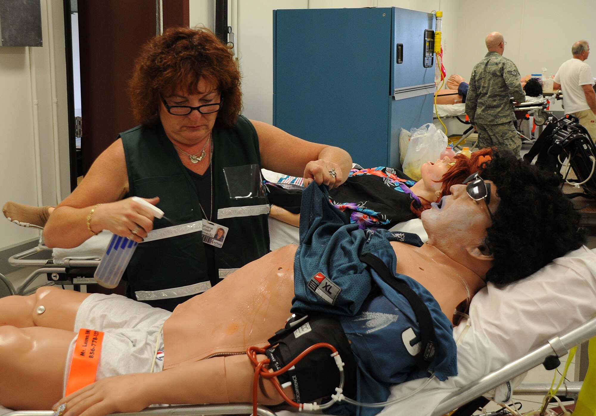 Lorraine Russell, a local paramedic, preps a mannequin before the start of a scenario for Eagle Flag Aug. 5 at Joint Base McGuire-Dix-Lakehurst. Hundreds of civilian responders and government officials participated in the exercise for the first time to test the region’s ability to respond to a major hurricane in New Jersey. (U.S. Air Force photo/Airman 1st Class Bryan Swink)