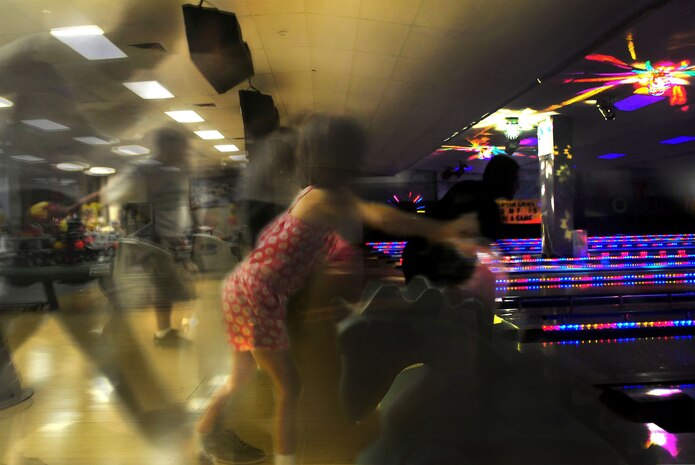 Bowlers at Joint Base Charleston hurl balls down the alley Aug. 7 at Starlifter Lanes on Joint Base Charleston, S.C. Members of Joint Base Charleston who bowled at the lanes Aug. 7 received their first game on the house. The lanes held the promotion to gain support for the worldwide one-day record for the most games bowled in a single day. The lanes totaled approximately 450 games for the day and their scores were submitted to be tallied with scores from around the world to beat the current record. (U.S. Air Force photo illustration/Staff Sgt. Daniel Bowles)