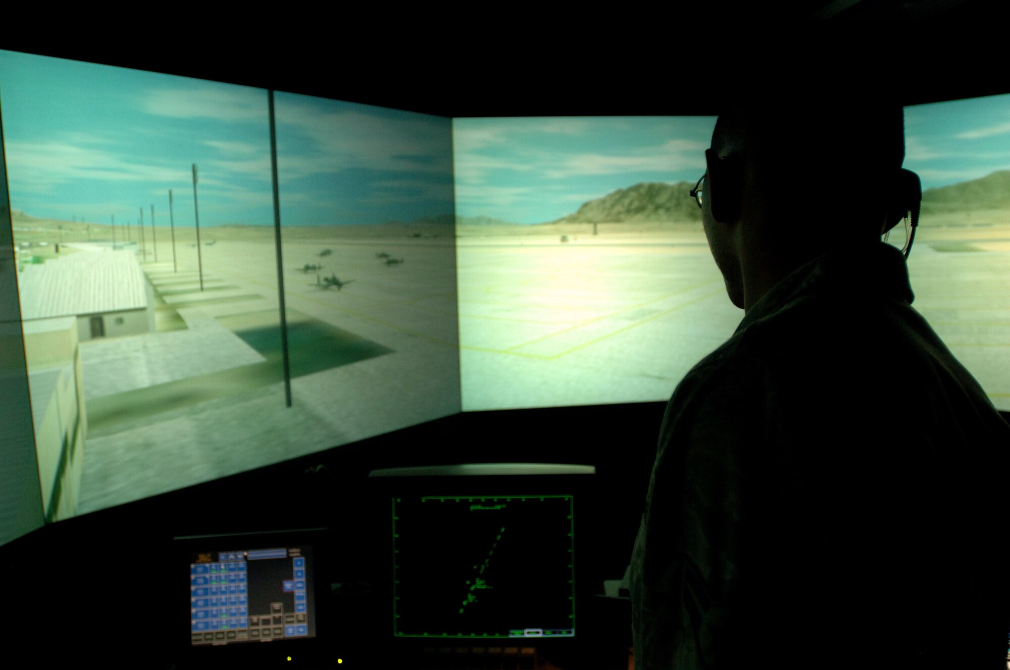 LANGLEY AIR FORCE BASE, Va. -- Airman 1st Class Aaric Ballard, 1st Operations Support Squadron air traffic controller, manages the simulated Joint Base Balad, Iraq airfield using the air traffic control tower simulator Aug. 11. Trainees use real equipment as they work though a variety of scenarios, using video simulations of airfield and airspace operations, designed to mimic actual tower operations in a safe training environment. (U.S. Air Force photo/Airman 1st Class Jason J. Brown)
