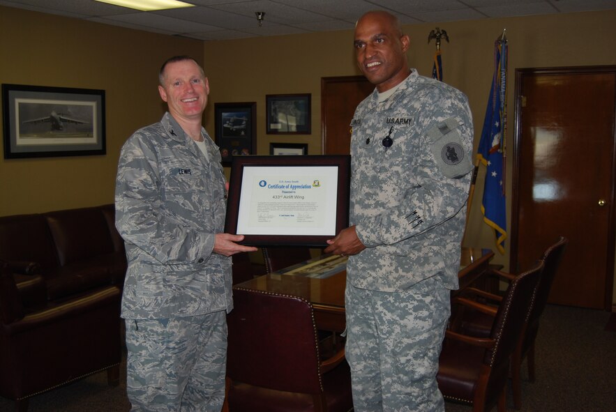 433rd AW commander, Col. Kenneth D. Lewis, Jr, accepts a certificate of appreciation from Lt. Col. Chad Livingstone, chief of staff for U.S. Army South, office of the deputy chief of staff G1, located at Fort Sam Houston in San Antonio, Texas.  Guests from USA SOUTHCOM visited the Alamo Wing as part of team-building activities to help strengthen the esprit de corps of the G1 Directorate. (U.S. Air Force Photo/Ms. Elsa Martinez)