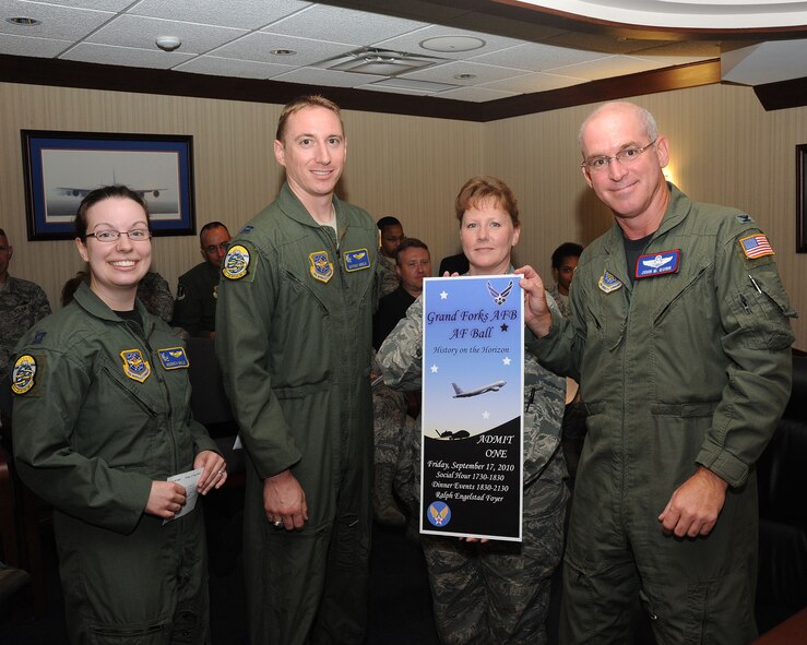 Col. John Quinn, 319th Air Refueling Wing vice-commander, buys the first ticket to the Grand Forks Air Force Base Air Force Ball Aug. 11. The ball will take place Sept. 17 at the Ralph Engelstad Arena Foyer. Tickets are on-sale now and can be bought through Company Grade Officers Association group representatives: Capt. Brent Chisholm, 319th ARW, 1st Lt. Ulises Atilano, 319th Medical Group, 1st Lt. Jonathan Barnes, 319th Mission Support Group, 2nd Lt. James Williams, 319th Maintenance Group and 2nd Lt. Anna Hall, 319th Operations Group. Ticket prices vary per person depending on pay-grade; E-1 to E-4 cost $10, E-5 to E-6 and GS-5 to GS-9 cost $15, E-7 to E-8, O-1 to O-2 and GS-11 to GS-12 cost $25 and E-9, O-3 and up and GS-12 and up cost $30. (U.S. Air Force photo by Tech. Sgt. Johnny Saldivar)