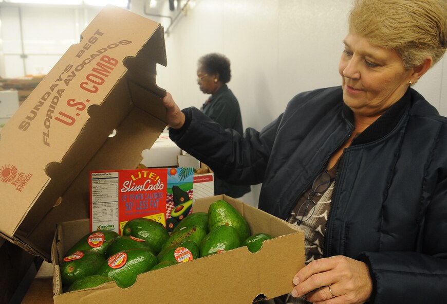BARKSDALE AIR FORCE BASE, La. - Christine Spain, Barksdale Commissary store director, helps quality check avocados in the receiving room Aug. 9 at the Barksdale Commissary. Trucks deliver fresh produce in the early morning Tuesday through Saturday every week and employees must receive and quality control all products. (U.S. Air Force photo/Senior Airman Amber Ashcraft) (RELEASED)
