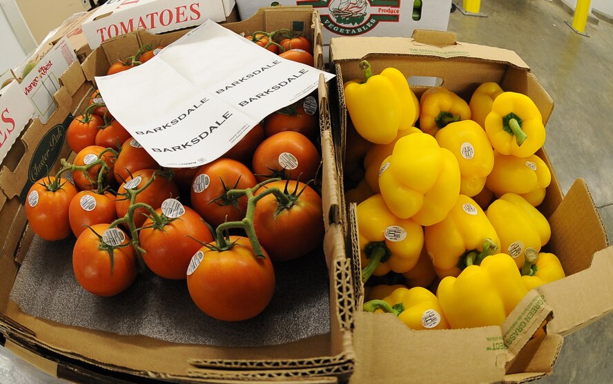 BARKSDALE AIR FORCE BASE, La. - Fresh tomatoes and yellow peppers are placed in the receiving room for inspection Aug. 9 at the Barksdale Commissary. Trucks deliver fresh produce in the early morning Tuesday through Saturday every week and employees must receive and quality control all products. (U.S. Air Force photo/Senior Airman Amber Ashcraft) (RELEASED)