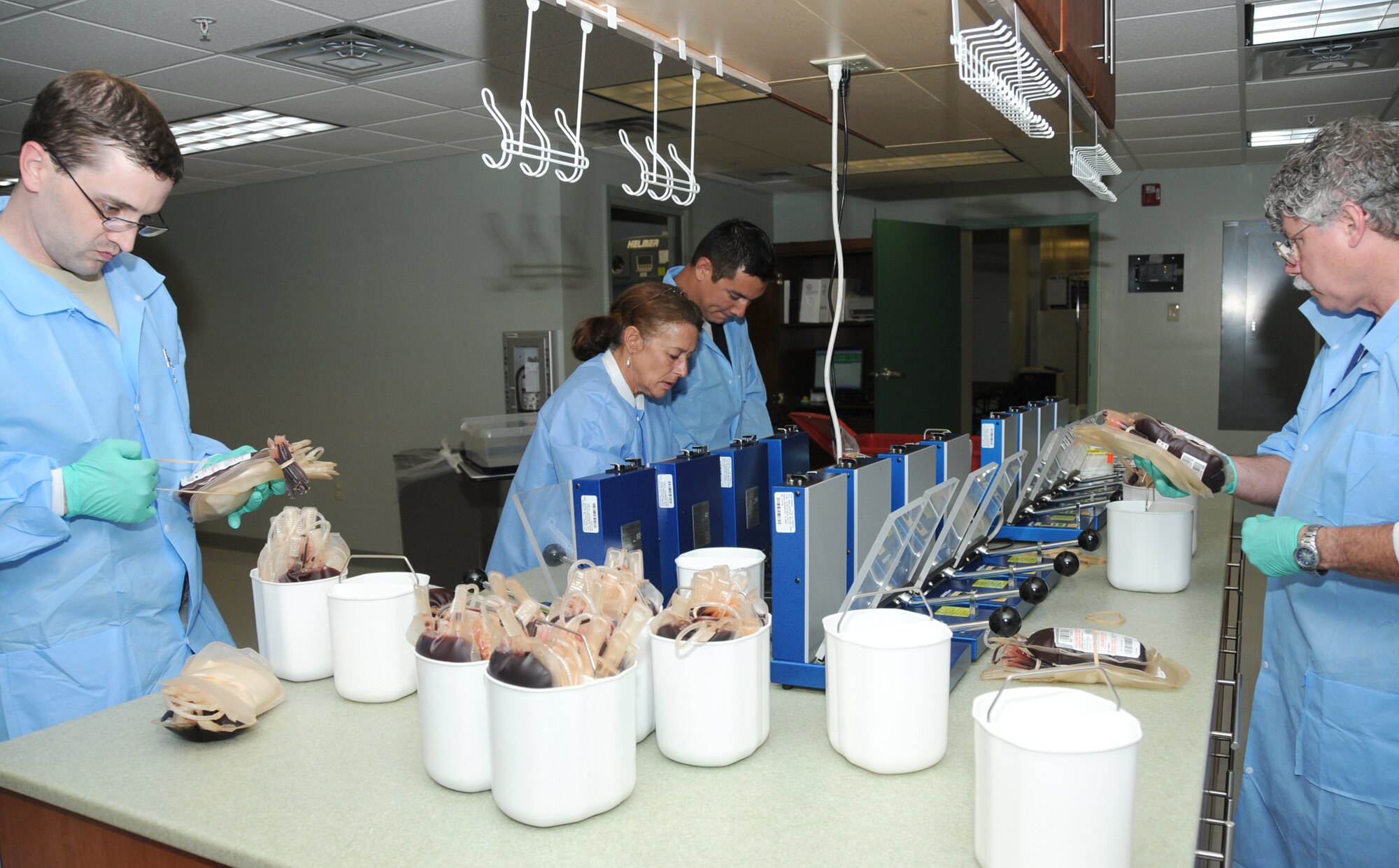 From left, Staff Sgt. Travis Gray, Sheila Mitchell, Robert Moody and Bill Meyer prepare blood to be separated and expressed.  They’re assigned to the 81st Diagnostics and Therapeutics Squadron.  (U.S. Air Force photo by Kemberly Groue)