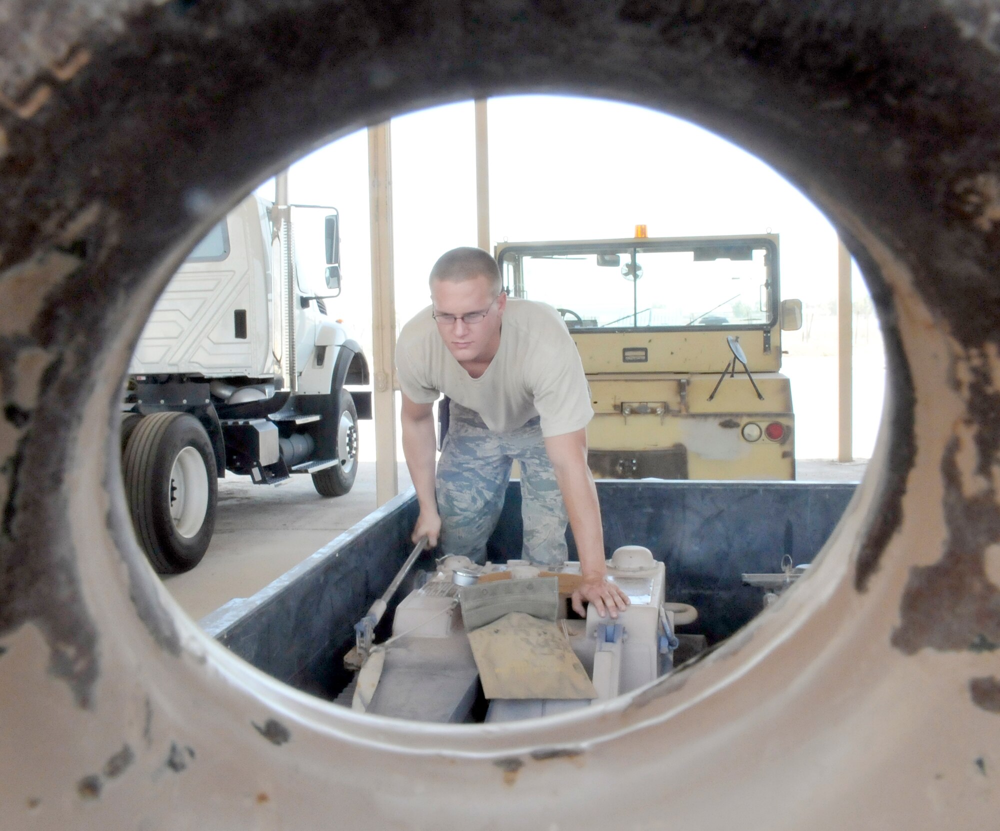 Senior Airman William Davenport pumps a wheel skate assembly to ensure serviceability July 9, 2010, at Joint Base Balad, Iraq. Wheel skates are used to help tow damaged aircraft from the airfield. Airmen Davenport is a 332 Expeditionary Maintenance Squadron crash recovery, wheel and tire technician. (U.S. Air Force photo/Staff Sgt. Phillip Butterfield) 