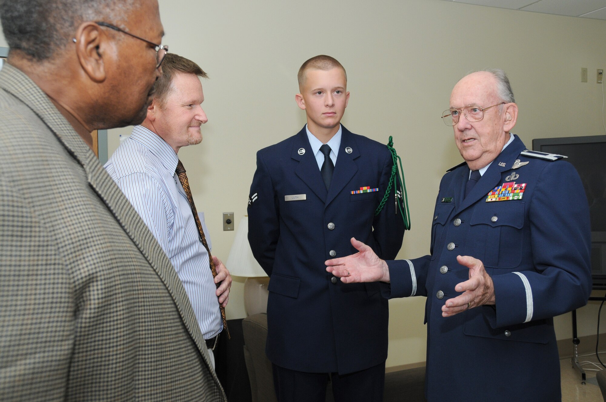 Retired Chief Master Sgt. Chris Moore, left, a former air traffic controller; Kevin Smart, an air traffic control instructor in the 334th TRS; and Airman 1st Class Kiefer Luth, 334th TRS, listen to retired Col. Derrel Dempsey, a "living legend" in the air traffic control arena.  Airman Luth was an Aug. 5 graduate of the air traffic control course at which his grandfather spoke.   (U.S. Air Force photo by Kemberly Groue)
