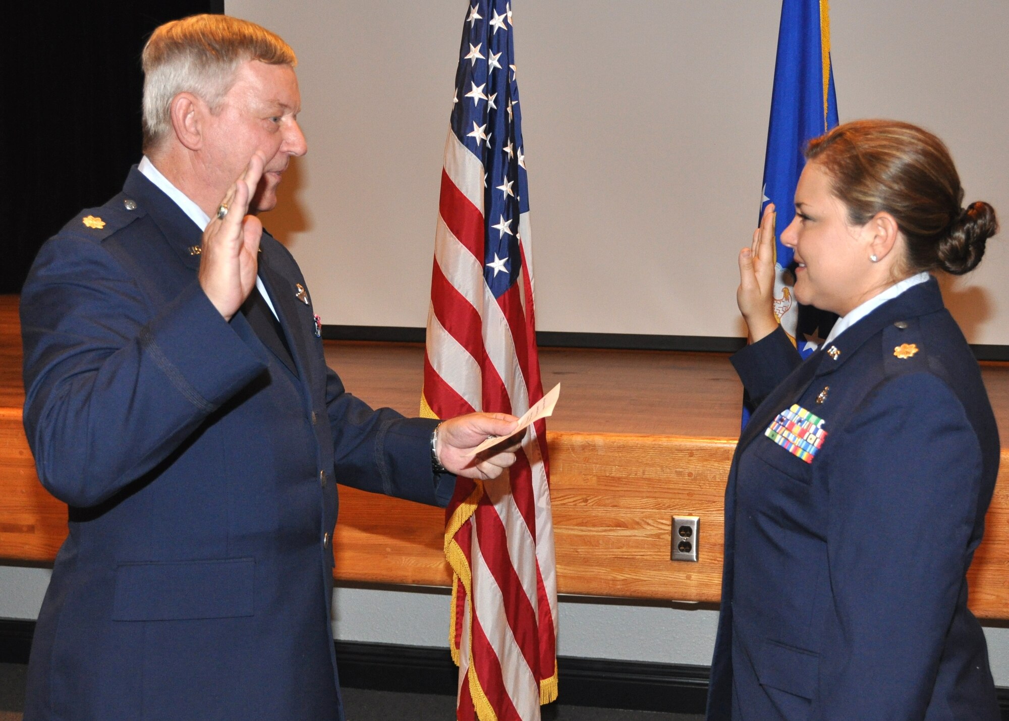 Retired Maj. Jack Jordan, left, administers the oath of office to his daughter, Maj. Amber Barker, during her July 30 promotion ceremony in the 81st Medical Group Hospital’s Don Wylie Auditorium.  Other members of Major Barker’s family were her mother Jenny; sister Maj. Amalia DiVittorio, a nurse at Maxwell Air Force Base, Ala., and brother Staff Sgt. John Jordon, Barksdale AFB, La.   Major and Mrs. Jordan reside in Tulsa, Okla., where he is an Air Force Junior ROTC instructor. The new major is element leader and nurse manager of the 81st Inpatient Operations Squadron’s family birthing center.  (U.S. Air Force photo by Steve Pivnick)