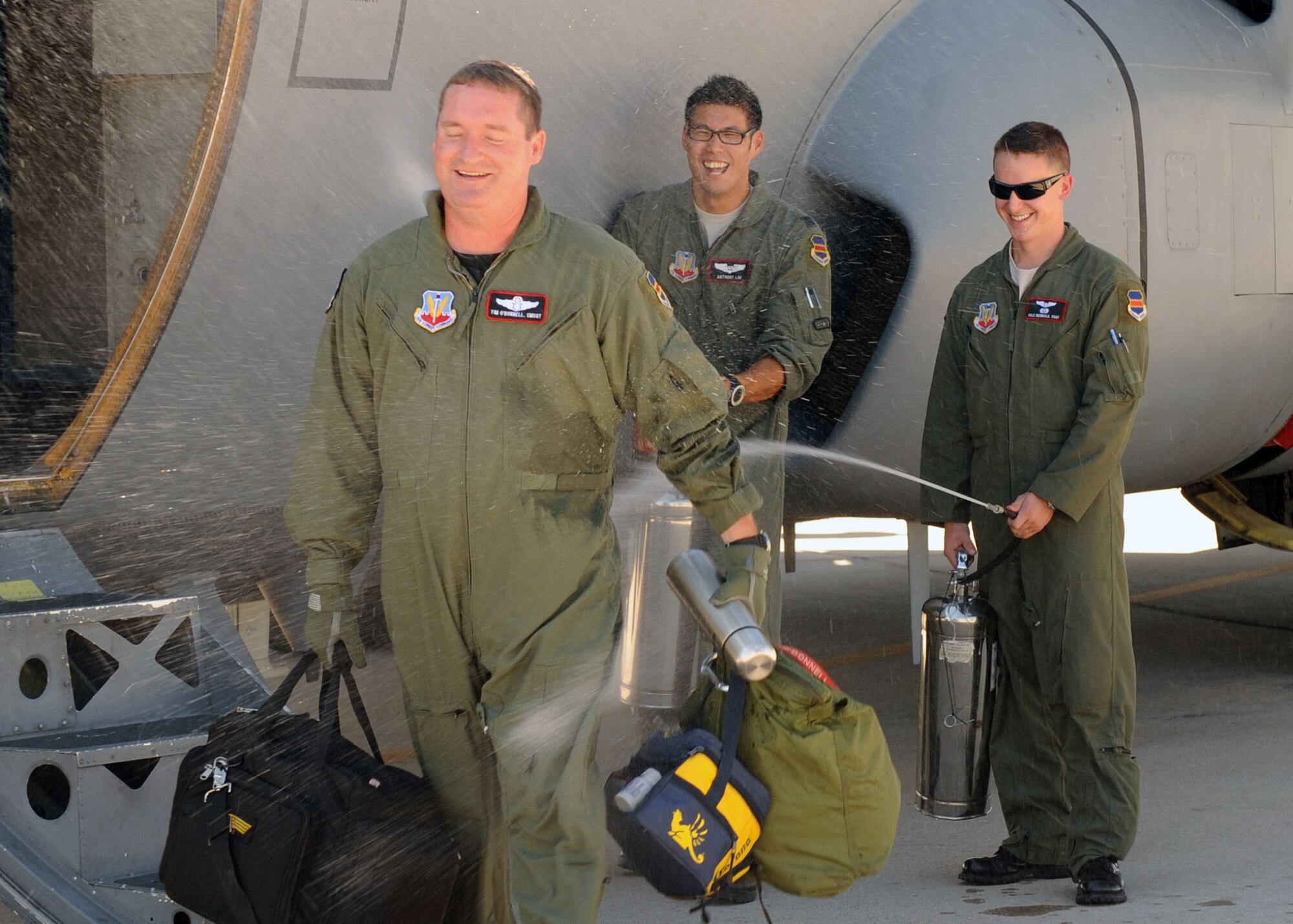 Senior Master Sgt. Timothy O'Donnell of the 43rd Electronic Combat Squadron
graciously tolerates a celebratory spray-down from squadronmates Capt. Anthony Lim (middle) and Staff Sgt. Cole Reinbold. Most of the 43rd ECS turned out to congratulate Sergeant O'Donnell for reaching 10,000 flight hours as an enlisted aviator. (U.S. Air Force photo/Airman 1st Class Brittany Dowdle)
