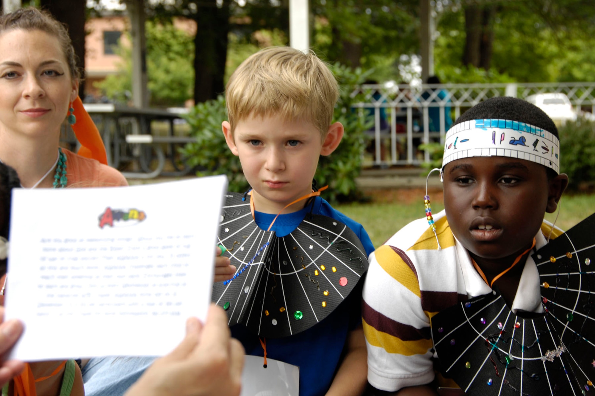 HANSCOM AIR FORCE BASE, Mass. – Joshua DeLory and Edward Harris wear Egyptian collars and listen to a story on Aug. 3 during Vacation Bible School at the Base Chapel. Children participated in activities, made crafts and learned about the Bible character Joseph who lived in ancient Egypt during the weeklong event. (U.S. Air Force photo by Linda LaBonte Britt)