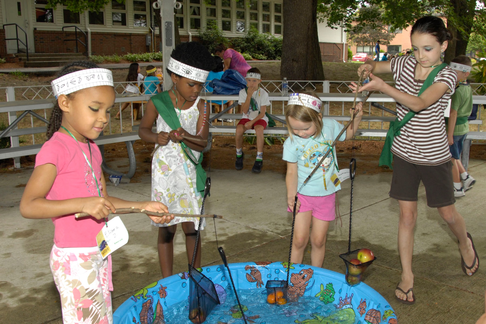 HANSCOM AIR FORCE BASE, Mass. – Eliana Williams, Ava Robinson, Katherine Gorton and Laurel Weissman (left to right) retrieve apples from a pool to represent fishing in the Nile River on Aug. 3 during Vacation Bible School at the Base Chapel. Children participated in activities, made crafts and learned about the Bible character Joseph who lived in ancient Egypt during the weeklong event. (U.S. Air Force photo by Linda LaBonte Britt)