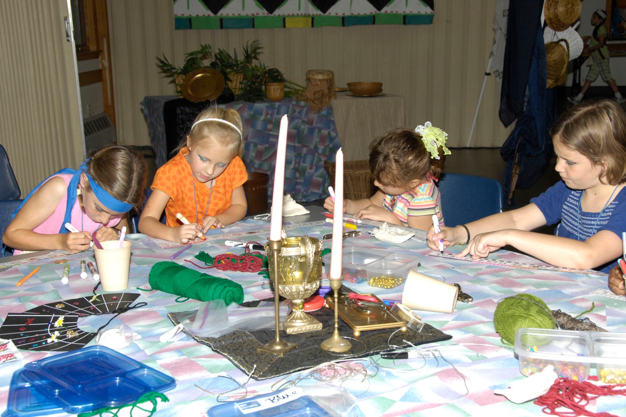 HANSCOM AIR FORCE BASE, Mass. – Mary Gatlin, Kassandra Menard, Hope Cerda and Angelina Seridio (left to right) make headbands on Aug. 3 during Vacation Bible School at the Base Chapel. Children participated in activities, made crafts and learned about the Bible character Joseph who lived in ancient Egypt during the weeklong event. (U.S. Air Force photo by Linda LaBonte Britt)