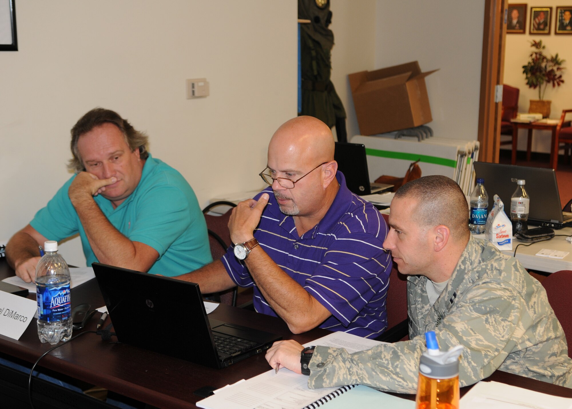MOODY AIR FORCE BASE, Ga. -- Students attending the Integrated Defense Risk Management Process and ForcePRO workshop work together teams to answer classroom exercises here July 30. The training is designed to teach students risk management principles through a new software program.