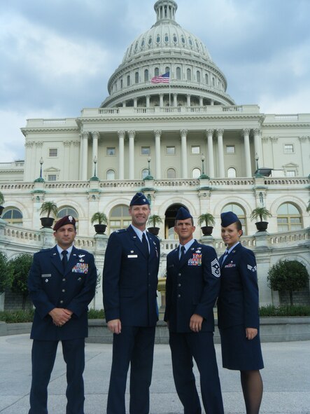 WASHINGTON, D.C. -- Captain Stephen Colletti, 48th Rescue Squadron director of operations, Col. Gary Henderson, 23rd Wing commander, Chief Master Sgt. Richard Parsons, 23rd WG command chief, and Senior Airman Amanda Goralski, 23rd Medical Group bioenvironmental engineering technician, take time to document their visit  near the Capitol with a photo July 27. Wing commanders and command chiefs choose two individuals annually to represent the enlisted and company grade officer ranks and accompany them to D.C.(Contributed photo/RELEASED)