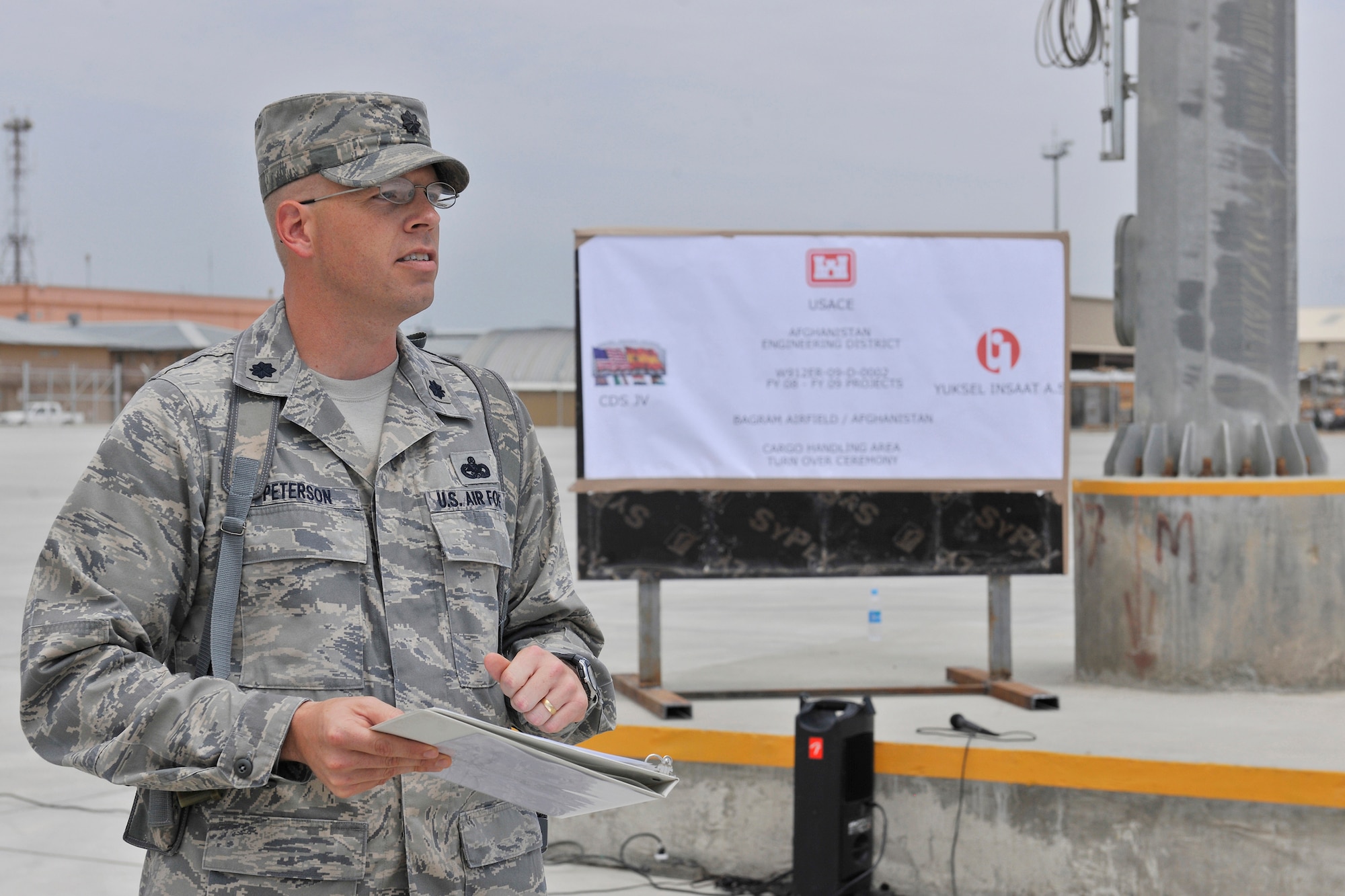 Lt. Col. Kirk Peterson, commander of the 455th Expeditionary Aerial Port Squadron, addresses aerial port Airmen, contractors and senior leaders during the new cargo handling ramp grand opening ceremony Aug. 11, 2010, Bagram Airfield, Afghanistan. The new ramp will increase the efficiency of the aerial porters and Bagram?s coalition partners. (U.S. Air Force photo/Staff Sgt. Christopher Boitz)