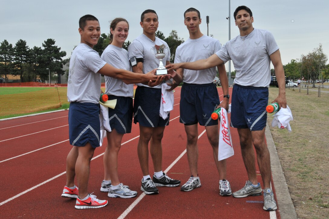 Capt. Thien Nguyen, Staff Sgt. Stacie McHugh, Senior Airman Javier Urteaga, Airman 1st Class Aaron Medina and Staff Sgt. Eric DeSouza of the 48th Medical Group stand with their prize for finishing first in the Commander’s Trophy PT Challenge August 6. The team completed the challenge with a time of 57 minutes and 26 seconds. (U.S. Air Force photo/Senior Airman David Dobrydney)