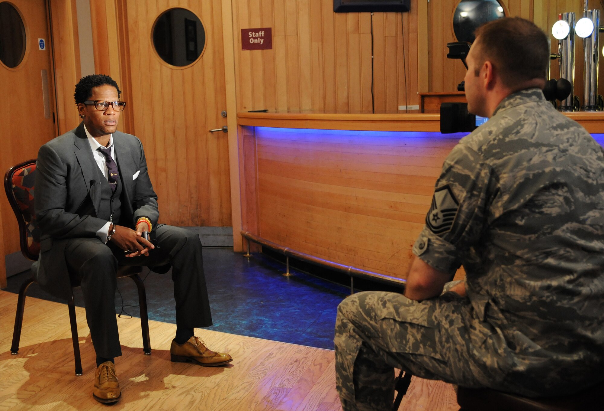 RAF MILENHALL, England -- Top-level comedian D.L. Hughley is interviewed by Master Sgt. Ron Flack, 100th Air Refueling Wing Public Affairs, before an Armed Forces Entertainment show here Aug. 4 at the Galaxy Club. His performance came after up and coming comedian Bryan Ricci opened the show that attracted more than 400 comedy fans. The performance is touring to military installations throughout Europe to boost unit morale. (U.S. Air Force photo/Staff Sgt. Thomas Trower)