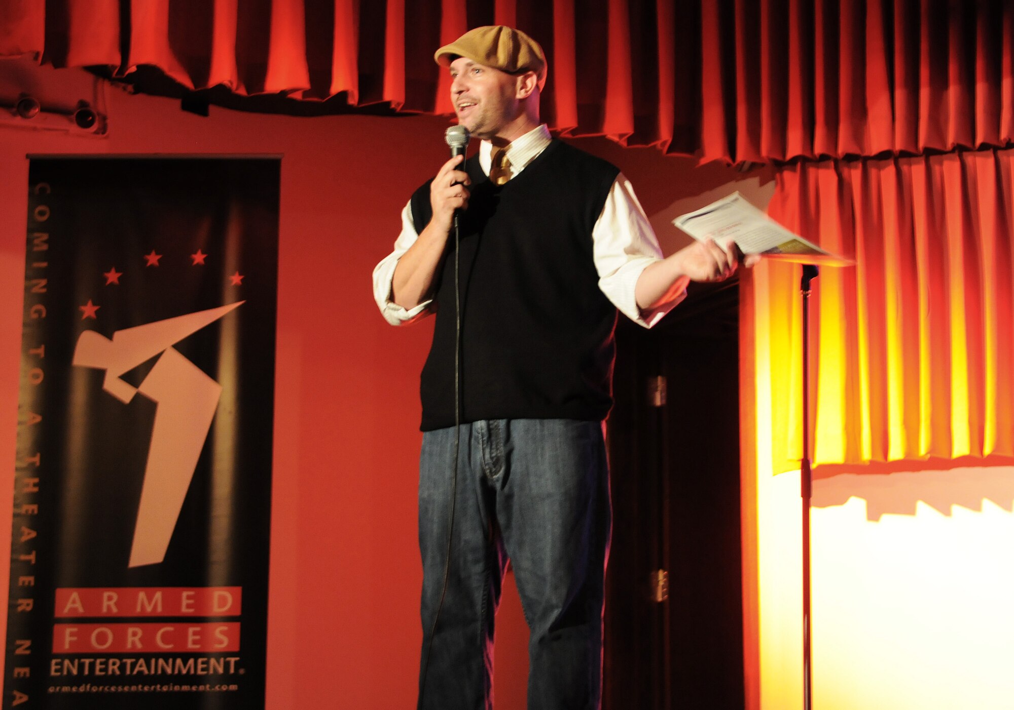 RAF MILENHALL, England -- Up and coming comedian Bryan Ricci opens an Armed Forces Entertainment show here Aug. 4 at the Galaxy Club. His performance was followed by top-level comedian D.L. Hughley, who attracted more than 400 comedy fans. The show is touring to military installations throughout Europe. (U.S. Air Force photo/Staff Sgt. Thomas Trower) 