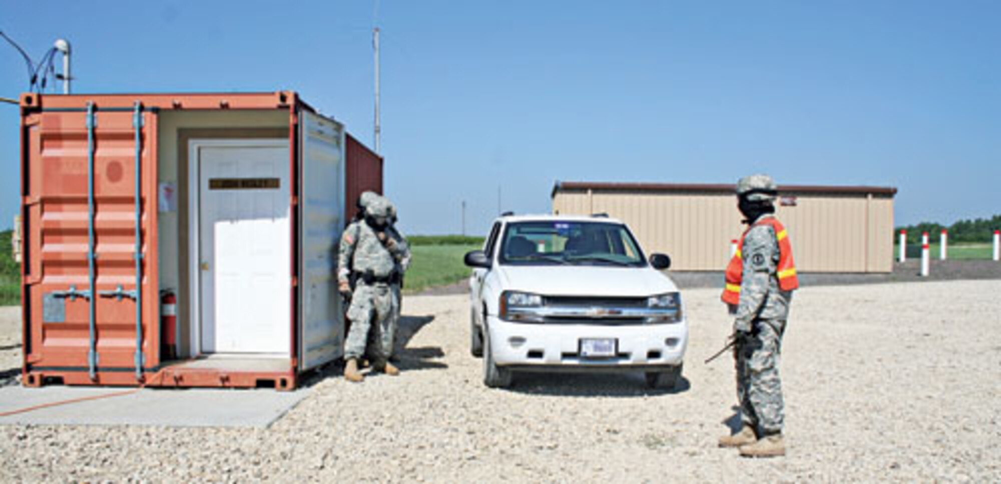Members of the 300th MP Co., 97th MP Bn., prepare to enter a building during active shooter training at Fort Riley Shoot House 1 on July 27.