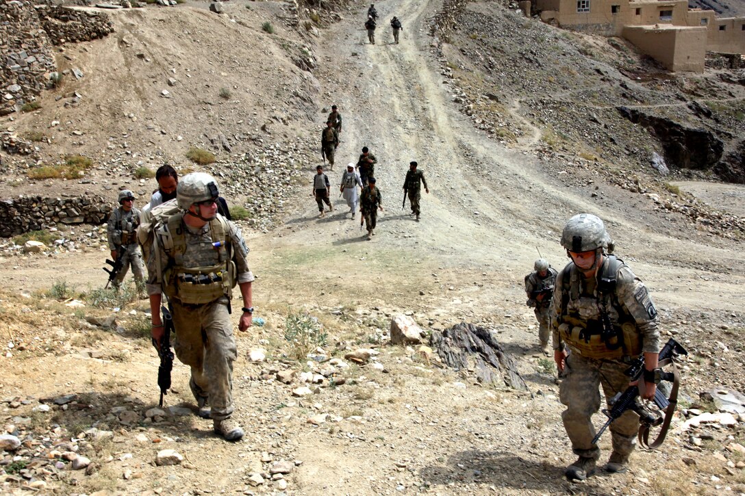U.S. Army soldiers walk up a hill an the end of a patrol in Shekhabad Valley, Wardak province, Afghanistan, Aug. 9, 2010.