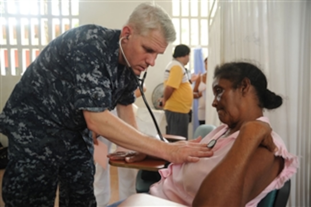 U.S. Navy Cmdr. Timothy Burgess conducts medical examinations during a Continuing Promise 2010 medical community service event in Colombia on Aug. 9, 2010.  