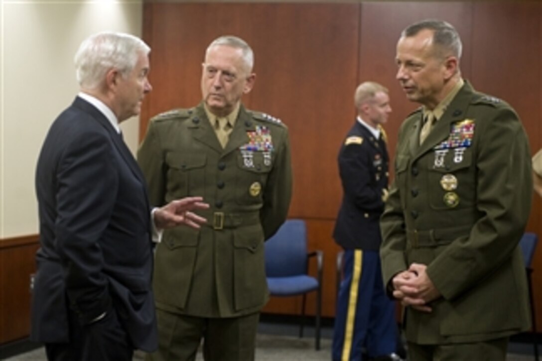 Secretary of Defense Robert M. Gates speaks with outgoing acting U.S. Central Command commander Lt. Gen. John Allen (right) and incoming commander Gen. James N. Mattis before an assumption of command ceremony at MacDill Air Force Base, Fla., on Aug. 11, 2010.  