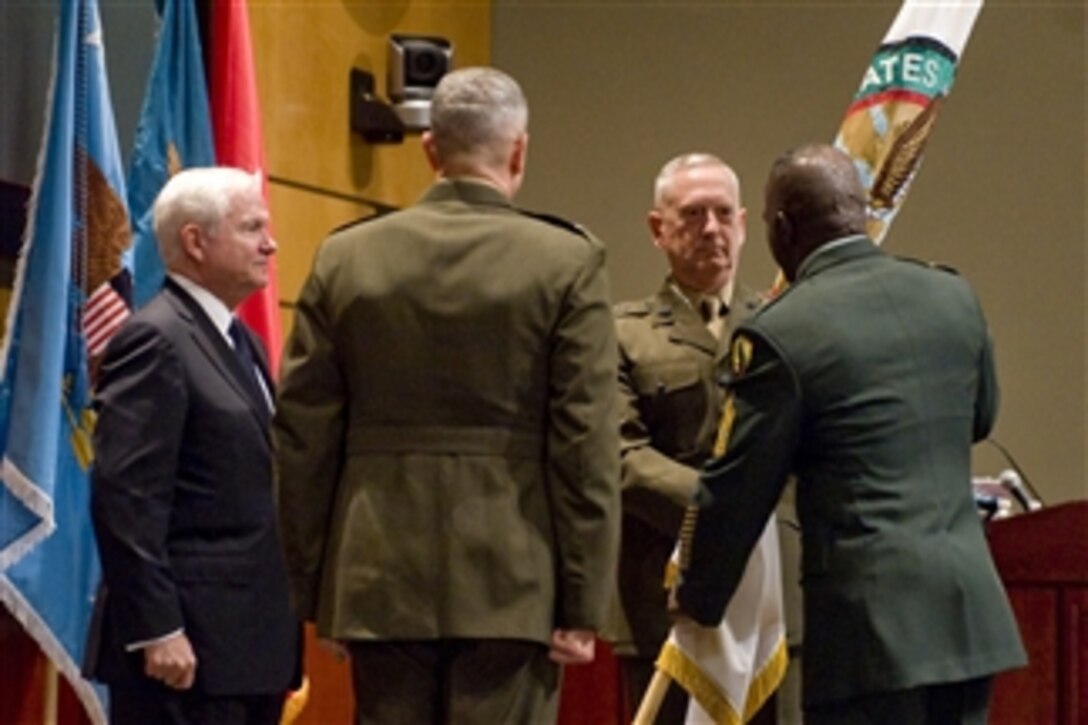 The incoming commander of U.S. Central Command Gen. James N. Mattis takes the flag signifying the assumption of command from outgoing acting commander Lt. Gen. John Allen (2nd from left) while Secretary of Defense Robert M. Gates looks on during an assumption of command ceremony at MacDill Air Force Base, Fla., on Aug. 11, 2010.  