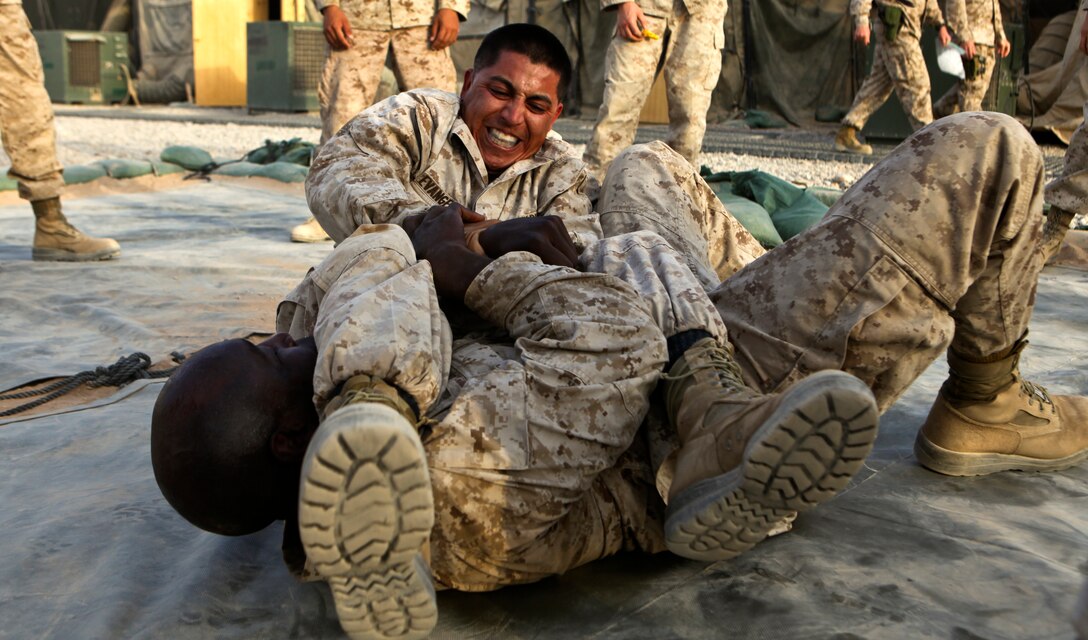 Sgt. Cesar Evangelista, an electrician with Marine Tactical Air Command Squadron 38, 3rd Marine Aircraft Wing (Forward), and Master Gunnery Sgt. Brad Brock, the communications chief for Marine Air Support Squadron 3, 3rd MAW (FWD), grapple during a brown belt Marine Corps Martial Arts Program class. Each Marine had to fight three, one-minute rounds back-to-back, which helped them learn to conserve energy and fight while fatigued.