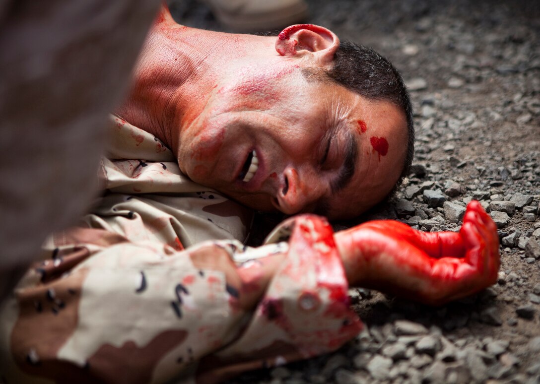 An Iraqi role player lies in a pool of fake blood after an IED blast rocked his vehicle in a convoy at MCTAB Friday.  Marines from Iraq Military Transition Team 973 (Team Shogun) from III MEF in Marine Corps Base Smedley D. Butler, Okinawa, Japan worked along side the role players in order to learn more about working jointly with Iraqis.