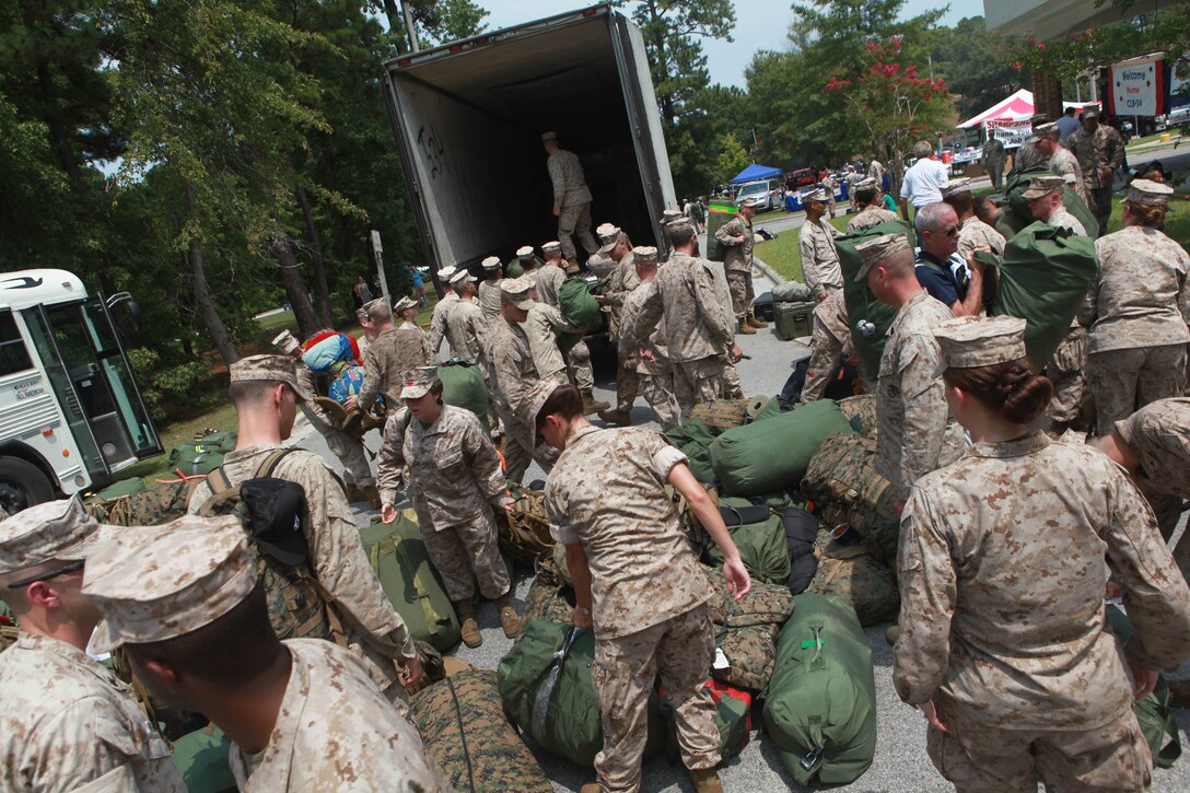 Marines  and Sailors with Combat Logistics Battalion 24, 24th Marine Expeditionary Unit, pull their gear off a truck at the French Creek recreation center on Aug. 12 after returning from a seven-month deployment .