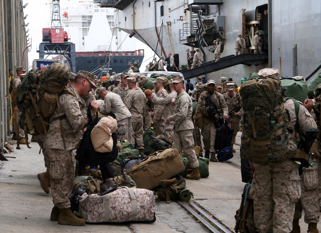 Marines with the 24th Marine Expeditionary Unit, unload their personal gear off the USS Nassau at Morehead City Port, NC Aug. 12. The Marines are returning from a seven-month deployment from Haiti, the Mediterranean and the Middle East.