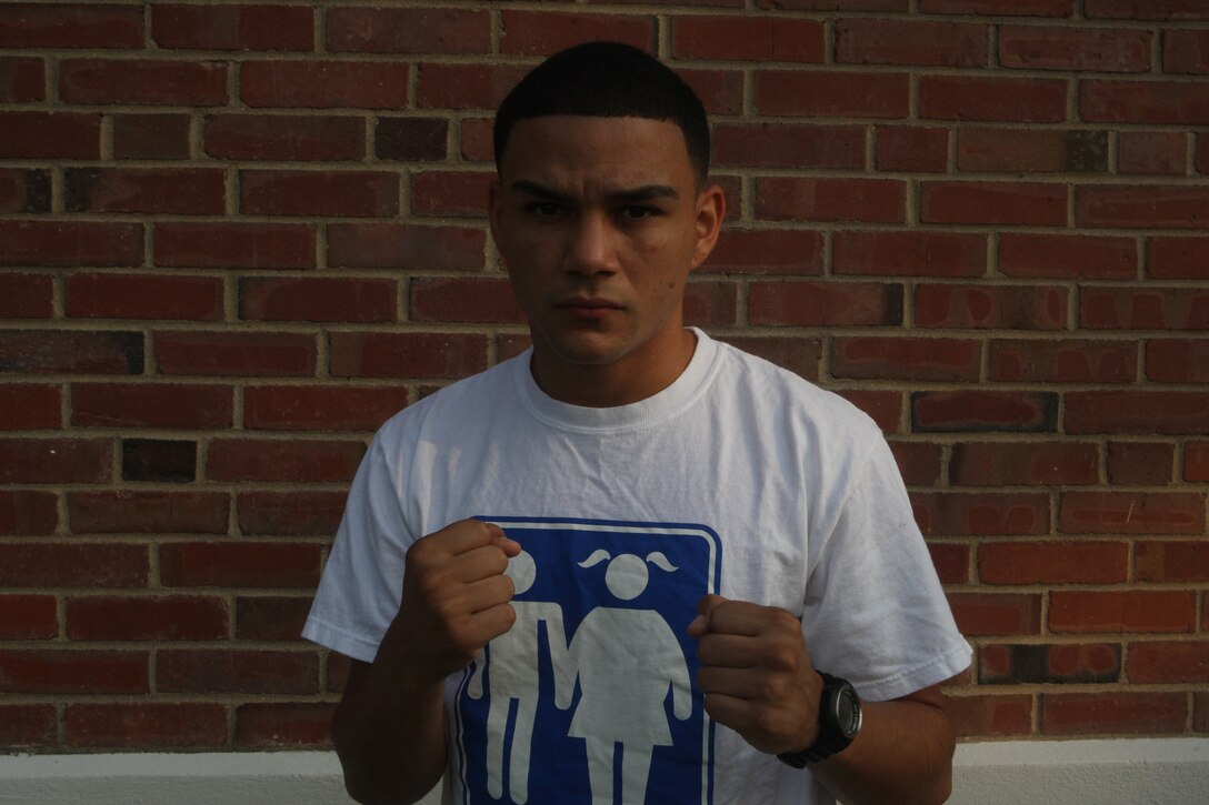 Lance Cpl. Tommy Roque, a boxer with the All-Marine Boxing Team, poses in front of the AMBT gym aboard Marine Corps Base Camp Lejeune before conducting physical training, Aug. 12. Roque and two other Marine boxers will be participating in the upcoming 53rd Conseil International du Sport Militaire's (International Military Sports Council's) World Military Boxing Championship to be held aboard Camp Lejeune in October.