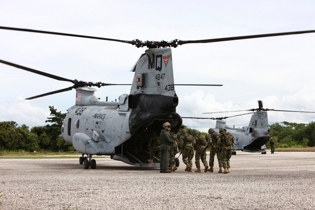 Colombian Marines enter a CH-46E Sea Knight helicopter with Marine Medium Helicopter Squadron 774 in preparation for a flight around Colombian Marine Corps Training Base Covenas in Colombia, Aug. 13, 2010, during a joint training exercise. ::r::::n::Marines from USS Iwo Jima conducted subject matter expert exchanges with Colombian Marines Aug. 9-17 in support of Operation Continuing Promise 2010, a humanitarian civic assistance mission. Marines and Sailors of Special-Purpose Marine Air-Ground Task Force CP10 are embarked aboard the USS Iwo Jima to the Caribbean, Central and South America on a four-month deployment.::r::::n::