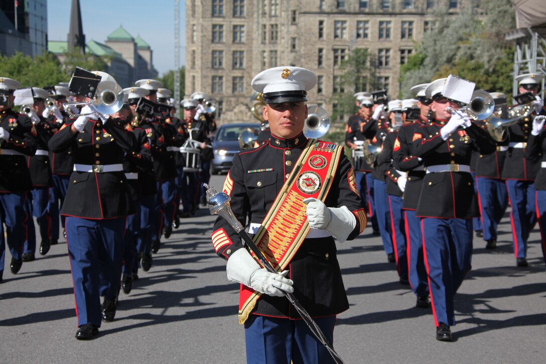 Gunnery Sgt. Victor D. Miranda, drum major for the 2nd Marine Aircraft Wing Band, marches with his Marines down the streets of downtown Ottawa, Canada, minutes prior to a performance at the 2010 Fortissimo Aug. 11. Miranda was one of several drum majors representing the 2nd MAW and Canadian Forces bands.