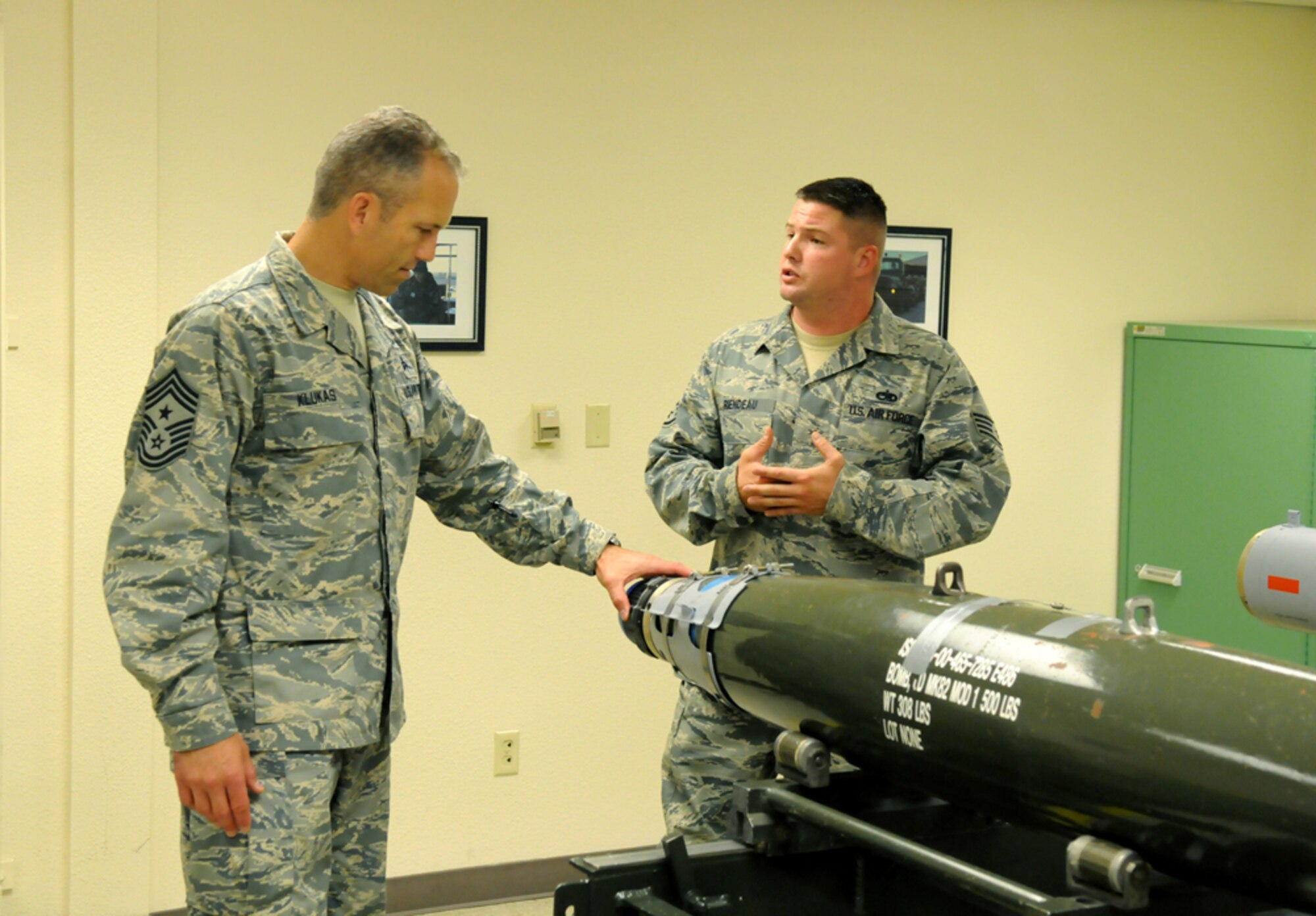 Staff Sgt. Marc Riendeau, 9th Munitions Squadron crew member, explains the components of a bomb to Chief Master Sgt. Martin Klukas, Air Combat Command command chief, Aug. 5 at the Air Force Combat Ammunition Center. Chief Klukas toured AFCOMAC and learned about their mission during his visit to Beale. (U.S. Air Force photo by Airman 1st Class David Tracy) 