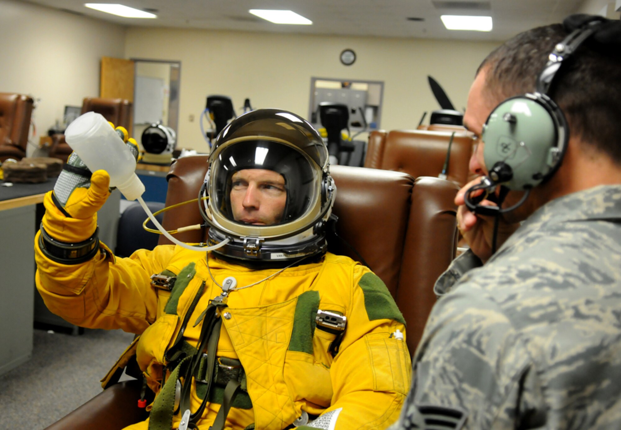 Chief Master Sgt. Martin Klukas, Air Combat Command command chief, drinks water while in a pressure suit Aug. 5 at the 9th Physiological Support Squadron integration room. Chief Klukas donned the suit as part of a demonstration of what U-2 pilots experience when they fly. (U.S. Air Force photo by Airman 1st Class David Tracy)