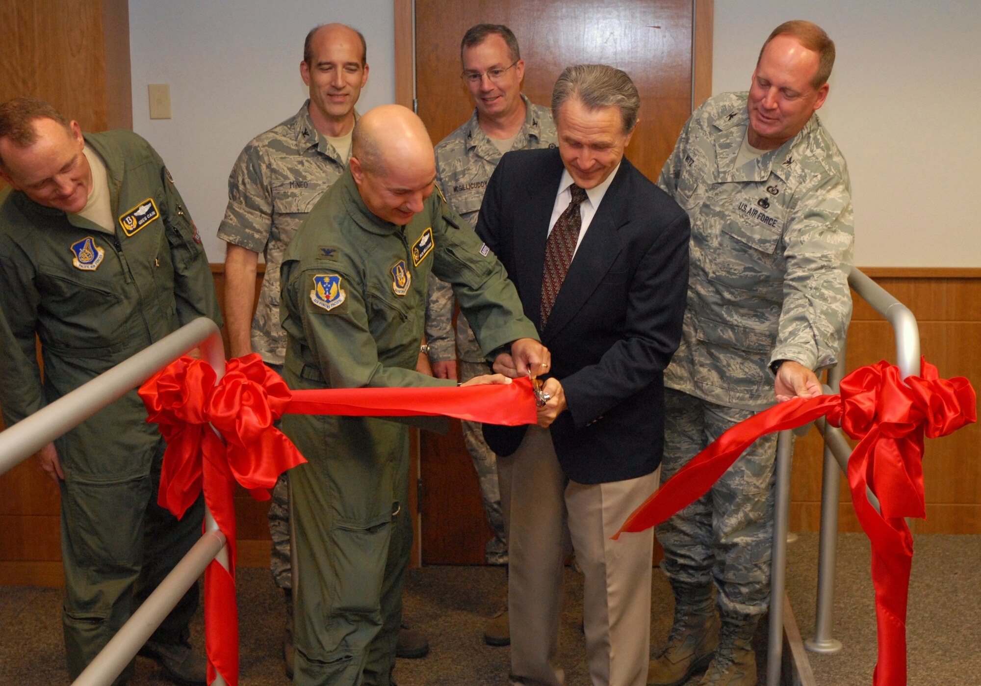 U.S. Rep. Wally Herger cuts the inaugural ribbon for 713th Combat Operations facilities. The California District 2 congressman joined Colonel Ben Williams, commander 713 COS for the honorary cut.  Looking on were (left to right) Colonel Gregory Cain,the Chief of Staff, representing commander 13th Air Force, Colonel Jeffrey Mineo, commander 940th Wing, Colonel Paul McGillicuddy, commander 9th Reconnaissance Wing and Colonel Jack Metz, Chief of Global Vigilance Division, Air Force Reserve Command.  (U.S. Air Force Photo/ Airman 1st Class Adam Hamar) 