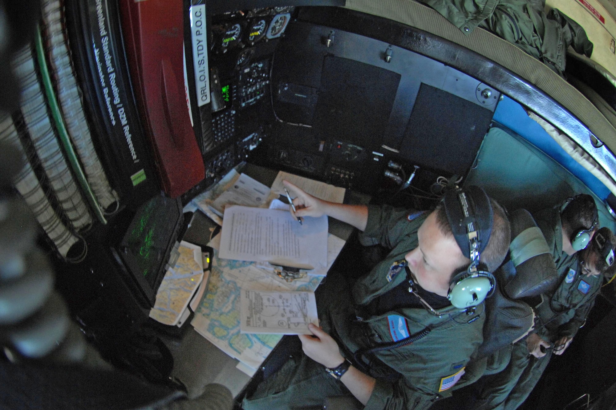 1st Lt. Drew Brewer navigates the sky July 28, 2010, over Greenland. The unit flies the only military aircraft in the world equipped with landing skis. It ferries scientists and supplies to the remote science research sites in Greenland. Lieutenant Brewer is with the New York National Guard's 109th Airlift Wing. (Department of Defense photo/Fred W. Baker III)