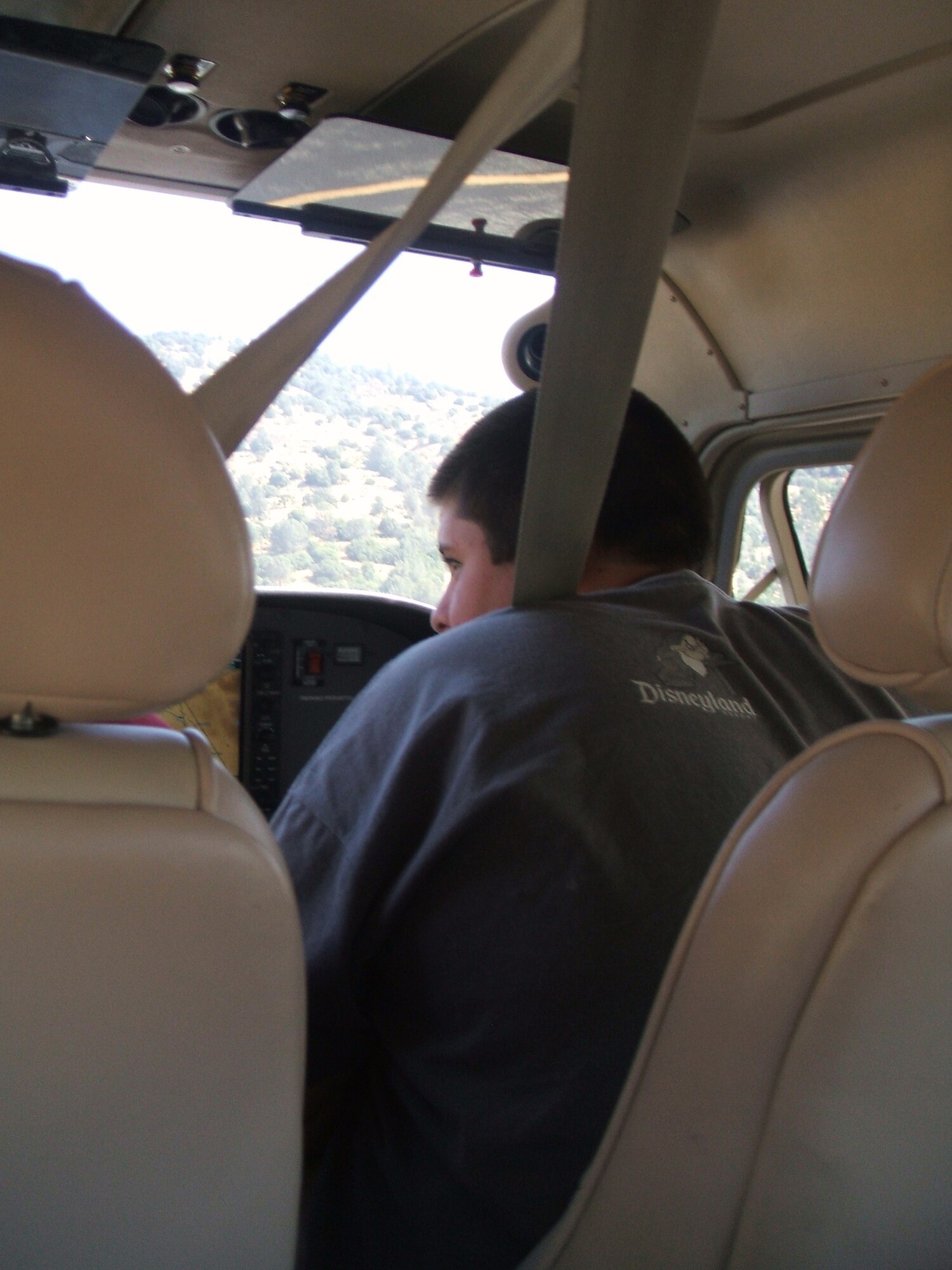 Paul Padilla looks out the window during his flight home to Hesperia, Calif., Aug. 8. Paul attended a camp for the deaf and was picked up by Tim Taylor, Edwards Aero Club certificated flight instructor.  Mr. Taylor is a command pilot for Angel Flight West, which provides free flights to medically, financially and geographically limited people.  (Courtesy photo)