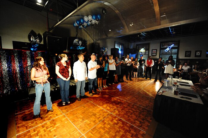 Participants wait as judges make the decision on the winners for Air Mobility Command ICON at Joint Base Charleston, S.C., Aug. 11, 2010. The command finals will include representatives from AMC?s 12 major installations and the top AMC affiliate unit participant. Each major installation within AMC will conduct their base-level AMC Icon contest during the months of July or August 2010. (U.S. Air Force photo/James M. Bowman)
