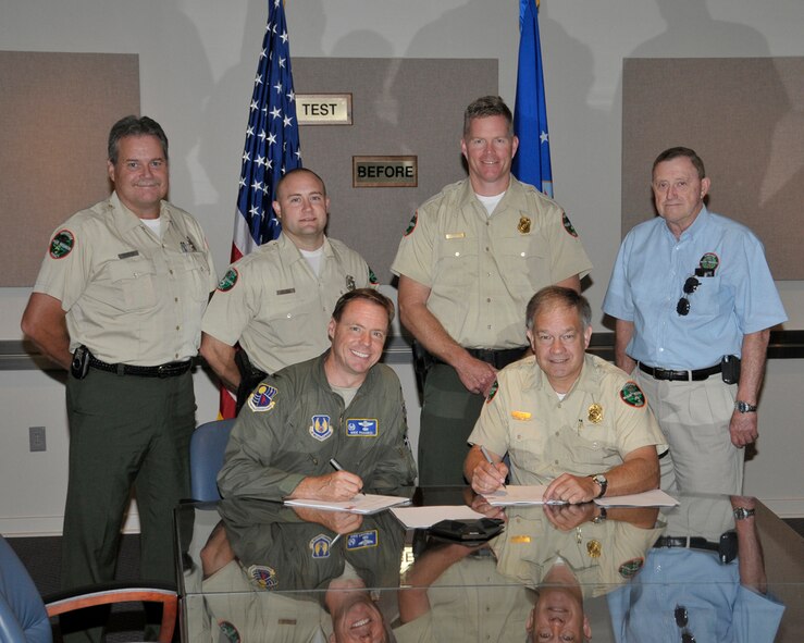 (L-R) Richard Kirk, TWRA Region 2 wildlife coordinator; Wes Winton, AEDC WMA manager; Tim Cleveland, Region 2 director; and George Buttrey, Region 2 lands management biologist, look on as AEDC Commander Col. Michael Panarisi and TWRA Executive Director Ed Carter sign an update of the 1991 MOA. TWRA provides wildlife management services, including hunt management, fish and wildlife surveys, wildlife population control, wildlife law enforcement, road improvements, wildlife habitat improvements, place fish attractors in Woods Reservoir, manage and maintain six boat launching ramps and the new ramp at Morris Ferry Dock. (Photo by Rick Goodfriend)