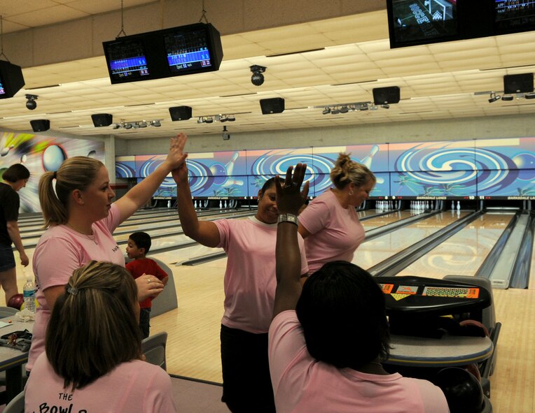 BARKSDALE AIR FORCE BASE, La. -- Team members give each other a high-five during the Air Force Global Strike Command bowling tournament Aug. 13. This was one of many events held to celebrate the AFGSC first year anniversary. (U.S. Air Force photo by Senior Airman La'Shanette V. Garrett) (RELEASED)